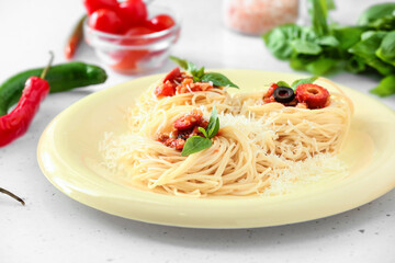 Plate of tasty Pasta Puttanesca on white background