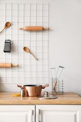 Copper cooking pot with saltcellar on counter in kitchen