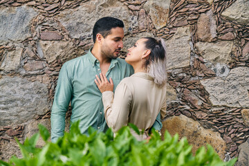 Young latin male and female couple looking at each other in love between 25 and 35 years old
