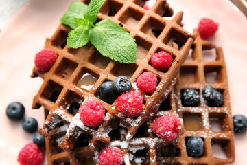 Delicious Chocolate Belgian Waffles with berries on plate, closeup