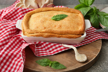 Baking dish with tasty mushroom pot pie on grunge background