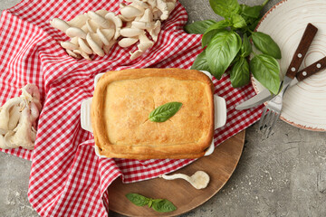 Baking dish with tasty mushroom pot pie on grunge background