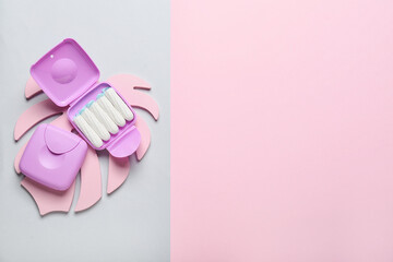 Tampons storage boxes on colorful background, top view