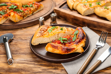Plate of tasty Turkish Pizza on wooden background