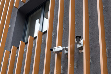 Security cameras on modern building. Professional surveillance camera. CCTV on the wall with LED IR lights. Security system, technology concept. Video equipment for safety system area control outdoor.