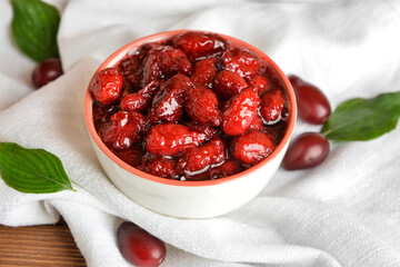 Bowl of tasty dogwood jam on table