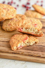 Wooden board with fresh cranberry cookies, closeup