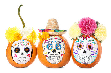 Pumpkins with painted skull on white background. Celebration of Mexico's Day of the Dead (El Dia de Muertos)