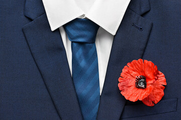 Poppy flower pinned on male clothes, top view. Remembrance Day