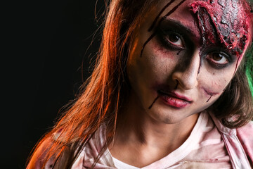 Scary zombie woman on dark background