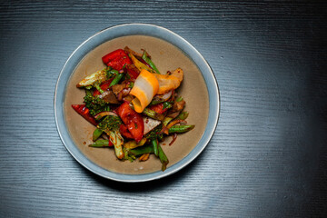 Top view of salad with meat and vegetables on a black background