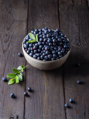 Blueberry bowl on wooden background with copy space in rustic style