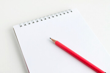 pink pencil lies on a white sheet of notepad, school topics, space for text