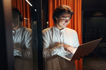 Man looking at screen of laptop with smile
