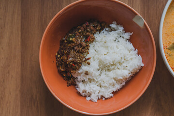 Stir fried pork with basil on topped boiled rice is popular thai style street food.