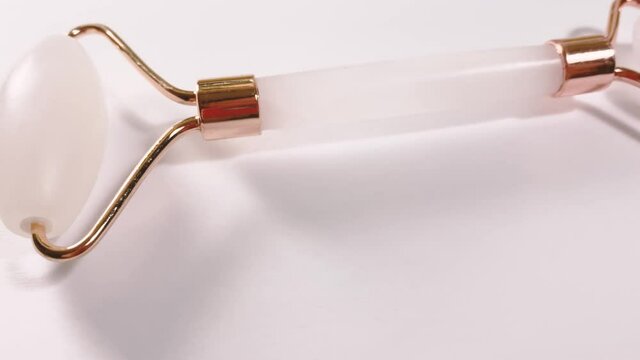 White massage quartz roller for the face close-up isolated on a white background. Beauty and care concept for women