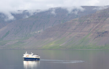 Dynjandi, Iceland on august 6, 2021: National Geographic explorer floating in the fjord near Dynjandi