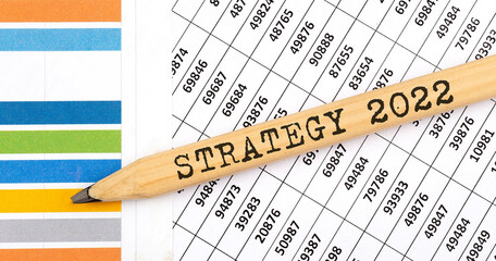 Business concept STRATEGY 2022 text on the pencil on chart background