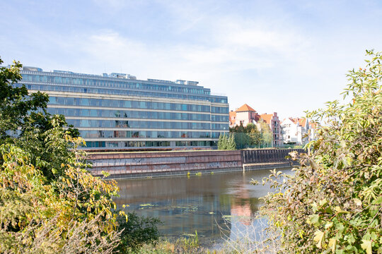 Warta river and modern buildings  in the old harbour, Poznan, Poland.
