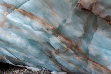 the texture of the blue ice of a mountain glacier