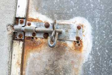 An old rusty metal bar without lock at an harbour