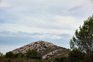 Rocky mountain Natural Park of Castelldefels with sky covered with clouds. Shot in natural morning light.