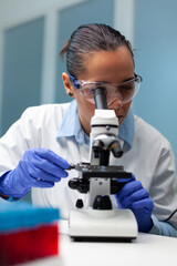 Biologist scientist developing vaccine against virus analyzing blood sample using medical...
