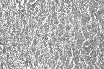Shiny silver foil texture background, pattern of wrapping paper with crumpled and wavy.