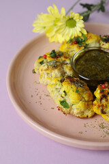 Concept of tasty food with baked cauliflower on violet background