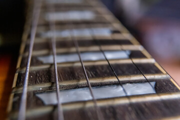 Arm, strings, and frets of classic electric guitar