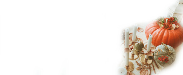 Pumpkins and candlesticks on a white background. Autumn banner. Copy space.