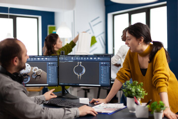 Coworkers engineer working on modern cad program developing industrial metallic construction....
