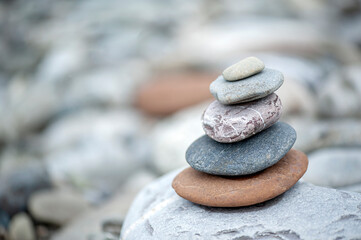 Folded pyramid of smooth stones on the seashore.