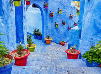 Chefchaouen Morocco. Typical bright blue staircase in the medina, decorated with colourful...