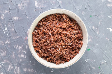 Rice red in bowl isolated on grey background. Asian food cooked.
