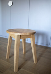 Wooden stool in natural color and simple design.