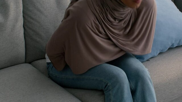 Unrecognizable Muslim Woman Having Stomachache Suffering From Abdominal Pain Indoor