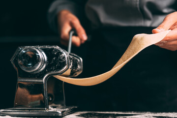 Close up photo of the pasta making machine in process.