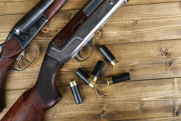 hunting rifles and cartridges on a wooden background top view with copy space studio photo shot
