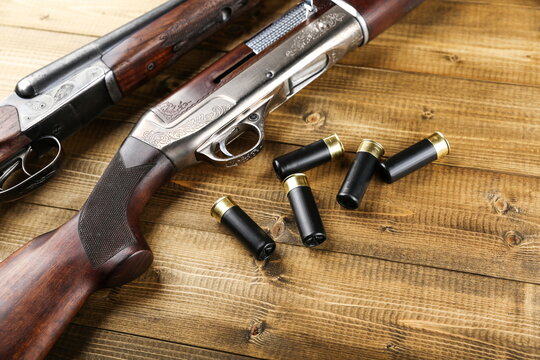 hunting rifles and cartridges on a wooden background top view with copy space studio photo shot
