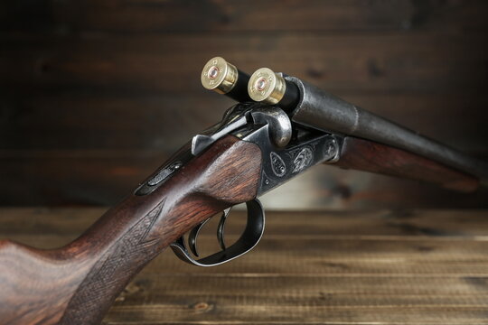 hunting rifle and cartridges on a wooden background studio photo shot