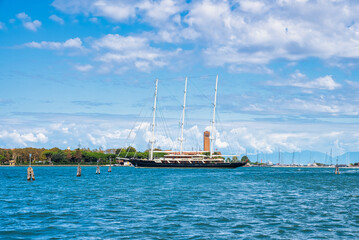 Obraz premium Huge sailing yacht entering Venice city in Italy. Luxury yacht sailing down the Adriatic sea in Venice.