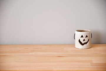 small halloween lantern on wooden table with grey background
