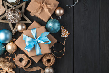 Christmas toys and gifts with blue ribbons on a black background.