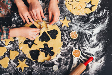 Top view photo of the gingerbread making process. Mom spending time with her daughter.
