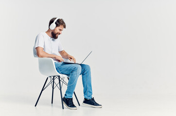 man in white t-shirt listening to music on headphones rest