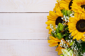 Wedding bouquet of sunflower on a wooden background. Top view with copy space.