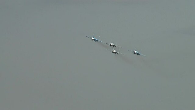 Four Sukhoi Su-27SM multi-purpose supersonic aircraft (NATO: Flanker-B) perform aerobatics in  group at celebration 100th anniversary of Russian military aviation. Zhukovsky, Russia - August 10, 201 
