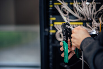 Man using network tool kit for setting up a gigabit ethernet. close-up.