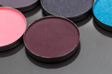 Close-up texture make-up eyeshadow palette. Abstract texture. Colorful colors. Highlighter. Professional make-up product. Flat lay. Macro photography. Set dry eyeshadow